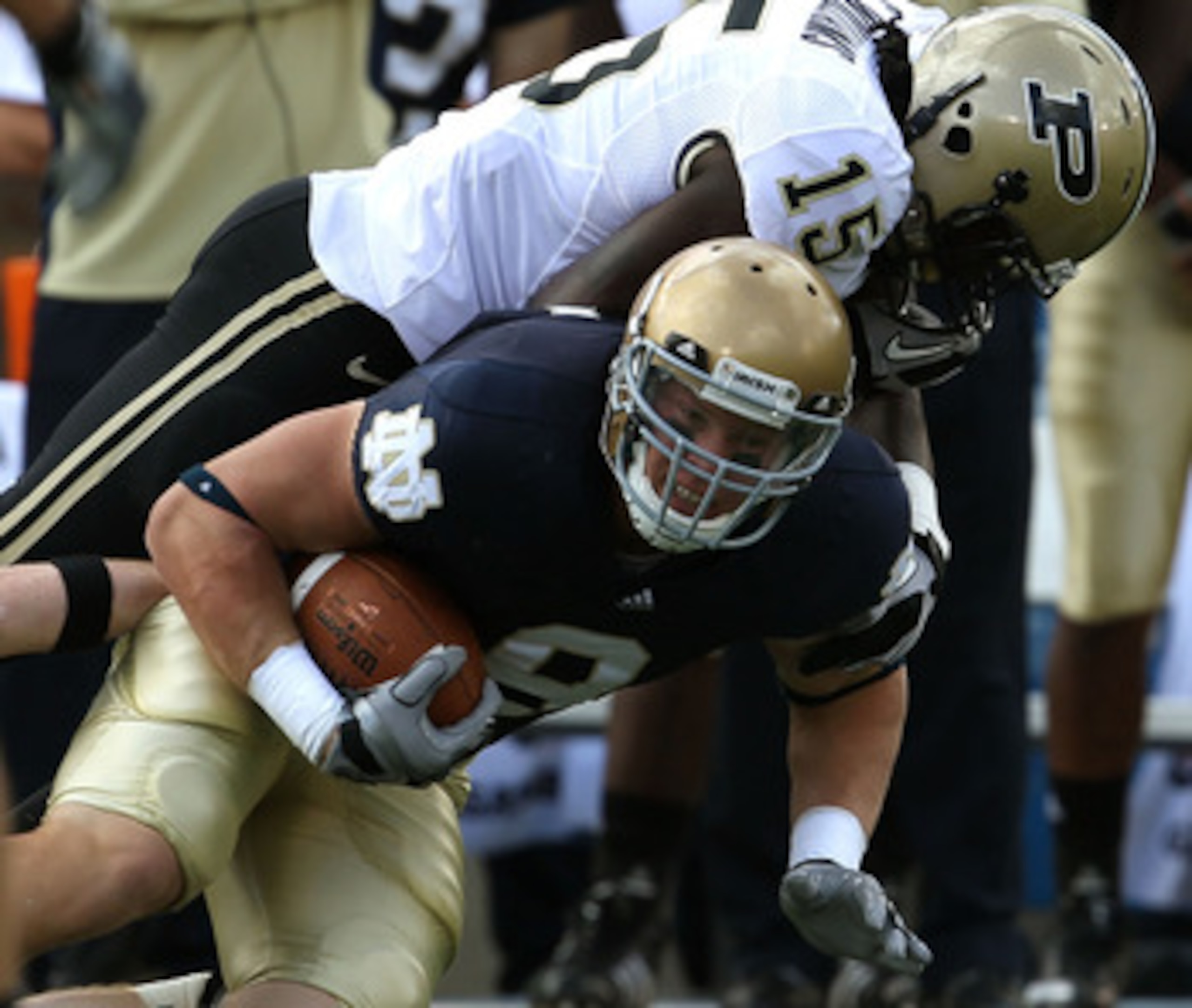 SOUTH BEND, IN - SEPTEMBER 04: Kyle Rudolph #9 of the Notre Dame Fighting Irish is tackled by Charlton Williams #15 of the Purdue Boilermakers at Notre Dame Stadium on September 4, 2010 in South Bend, Indiana. Notre Dame defeated Purdue 23-12. (Photo by J