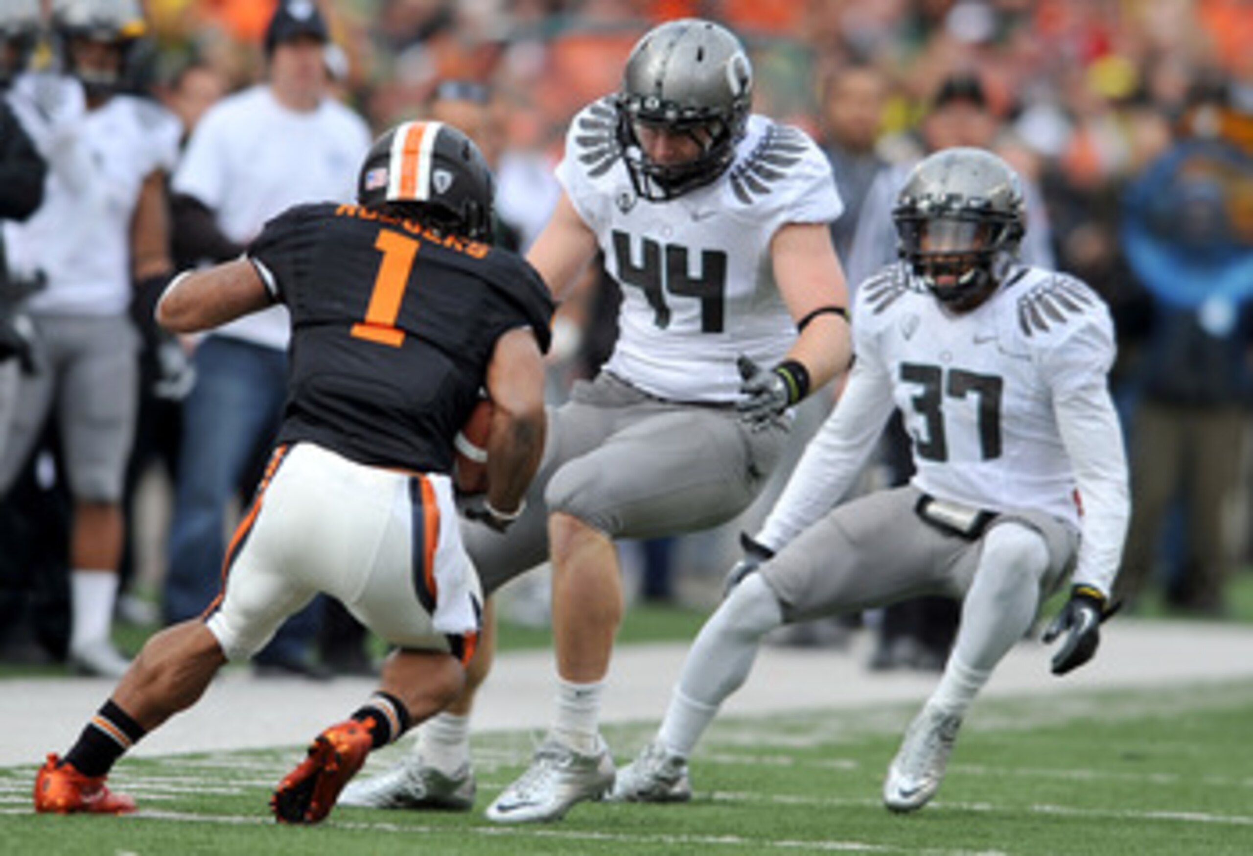 CORVALLIS, OR - DECEMBER 4: Brandon Hanna #44 and Talmadge Jackson III #37 of the Oregon Ducks close in on Jacquizz Rodgers #1 of the Oregon State Beavers in the second quarter of the game at Reser Stadium on December 4, 2010 in Corvallis, Oregon. The Duc