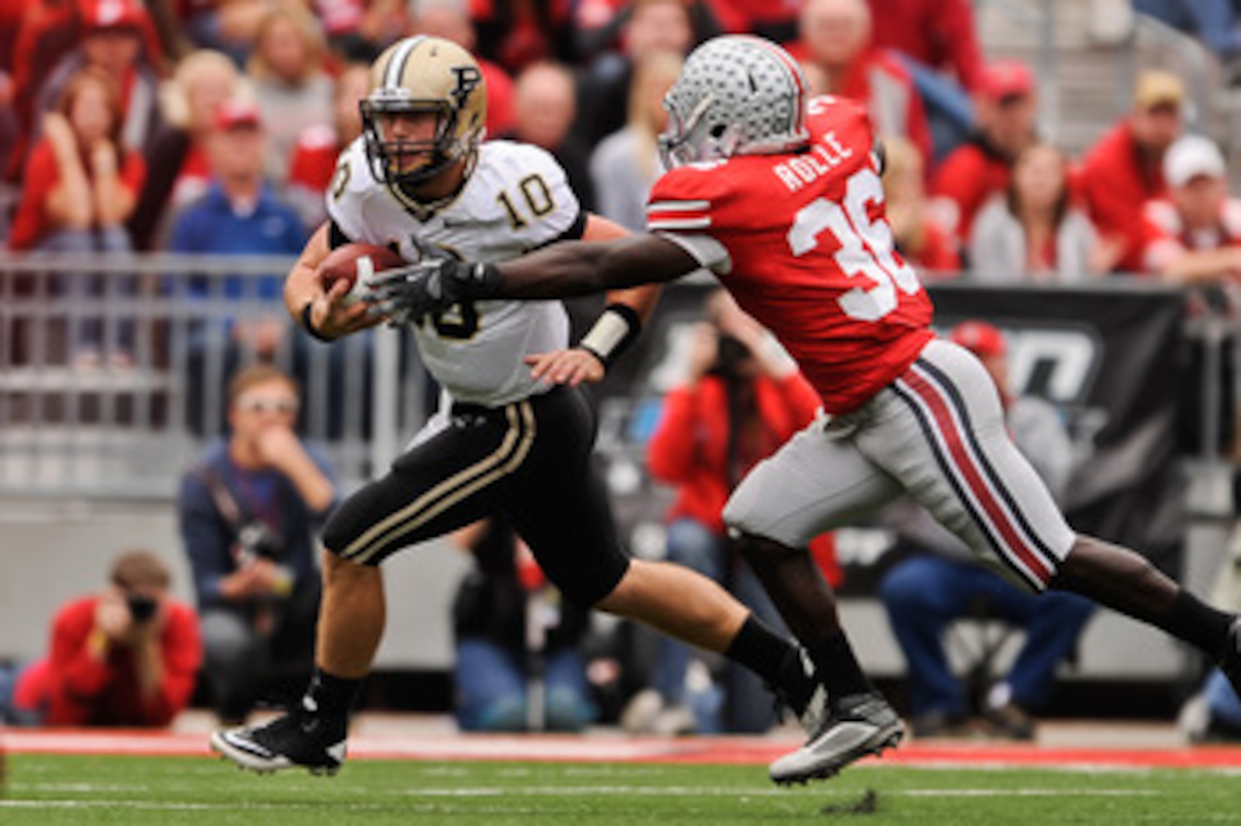 COLUMBUS, OH - OCTOBER 23:  Brian Rolle #36 of the Ohio State Buckeyes attempts to tackle Sean Robinson #10 of the Purdue Boilermakers at Ohio Stadium on October 23, 2010 in Columbus, Ohio.  (Photo by Jamie Sabau/Getty Images)