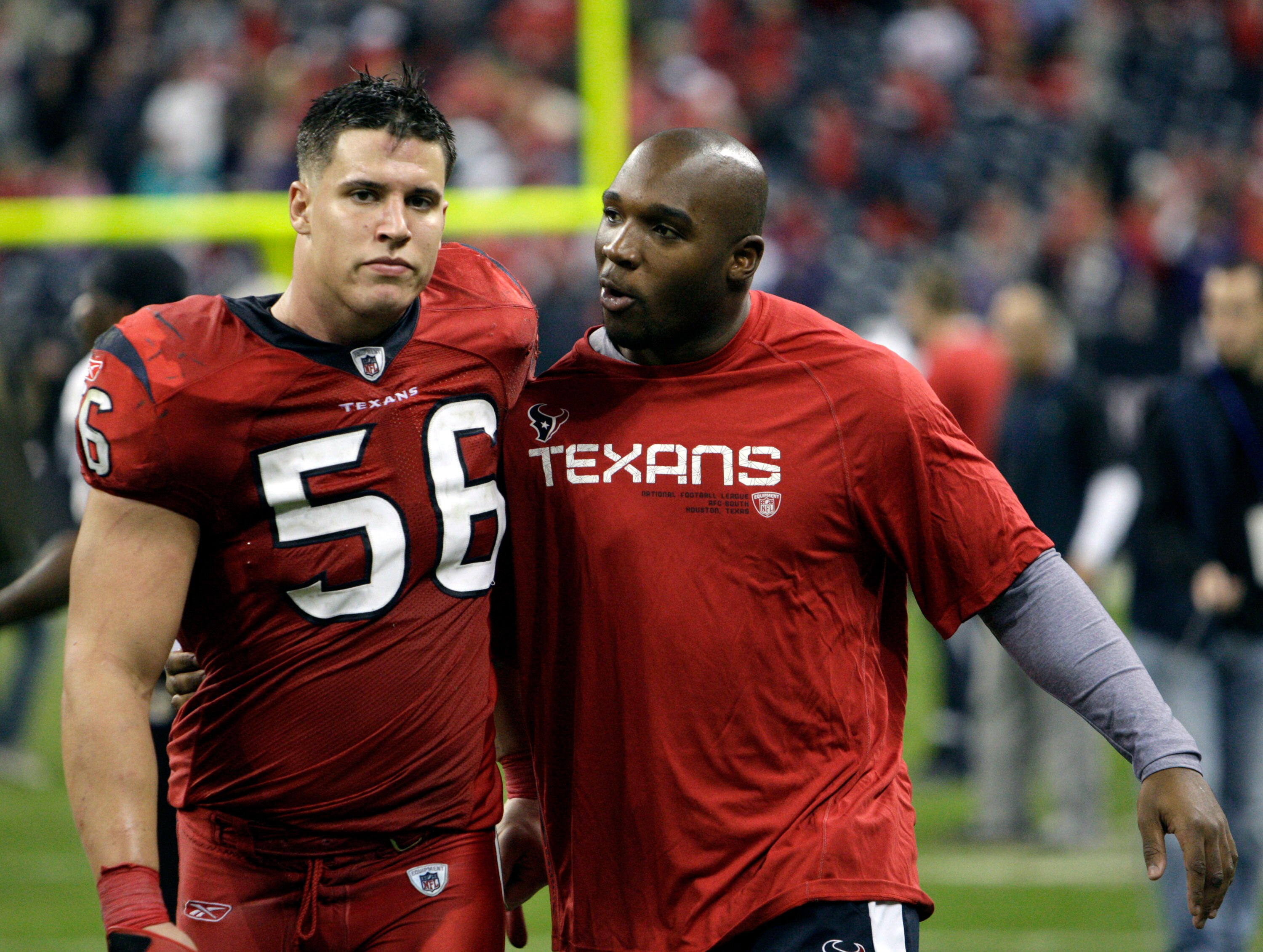 HOUSTON, TX - DECEMBER 13:  Linebacker Brian Cushing #56 and injured linebacker DeMeco Ryan walk off the field after Houston lost in overtime to Baltimore Ravens at Reliant Stadium on December 13, 2010 in Houston, Texas.  (Photo by Bob Levey/Getty Images)