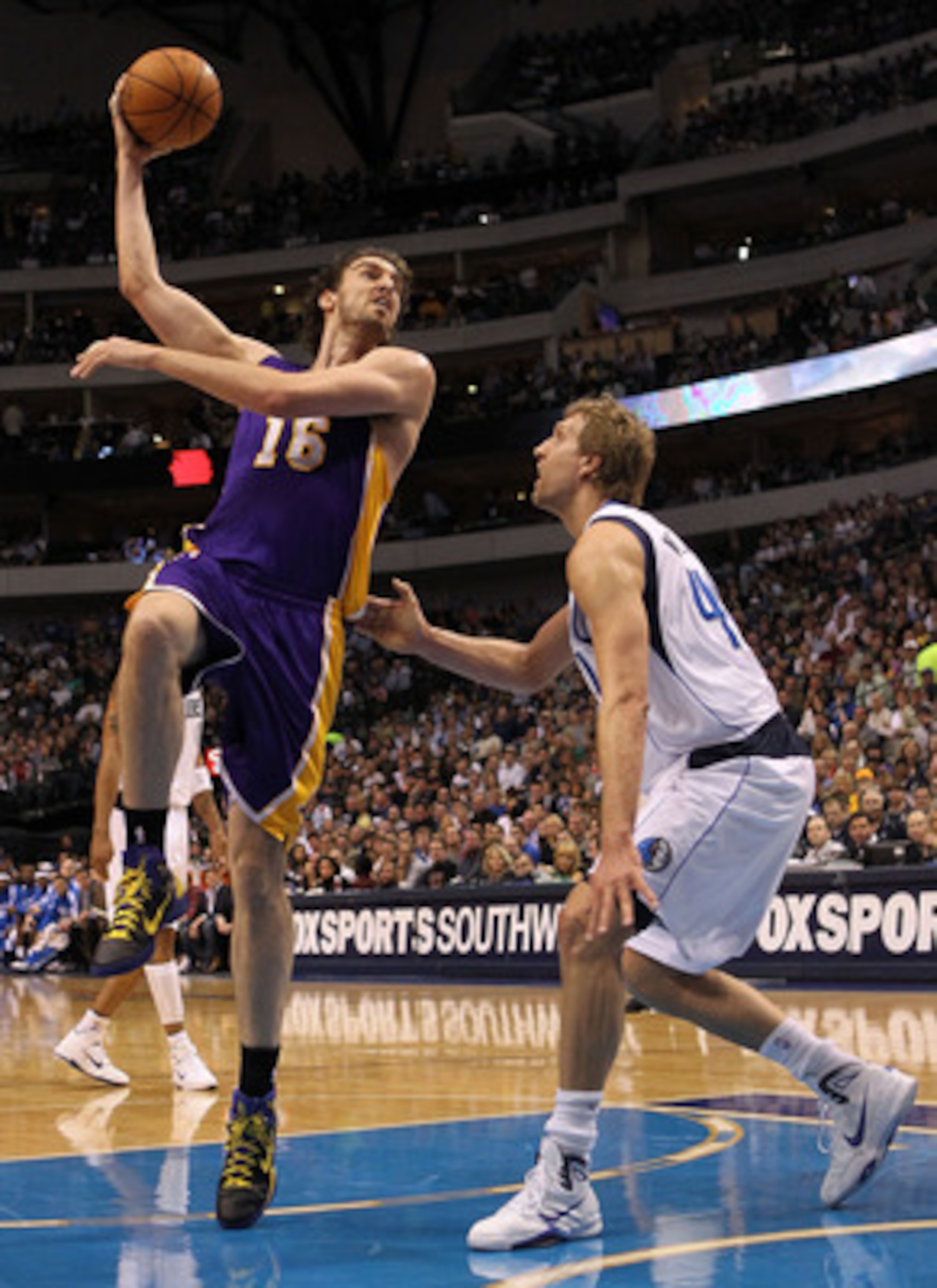 DALLAS, TX - MARCH 12:  Forward Pau Gasol #16 of the Los Angeles Lakers takes a shot against Dirk Nowitzki #41 of the Dallas Mavericks at American Airlines Center on March 12, 2011 in Dallas, Texas.  NOTE TO USER: User expressly acknowledges and agrees th