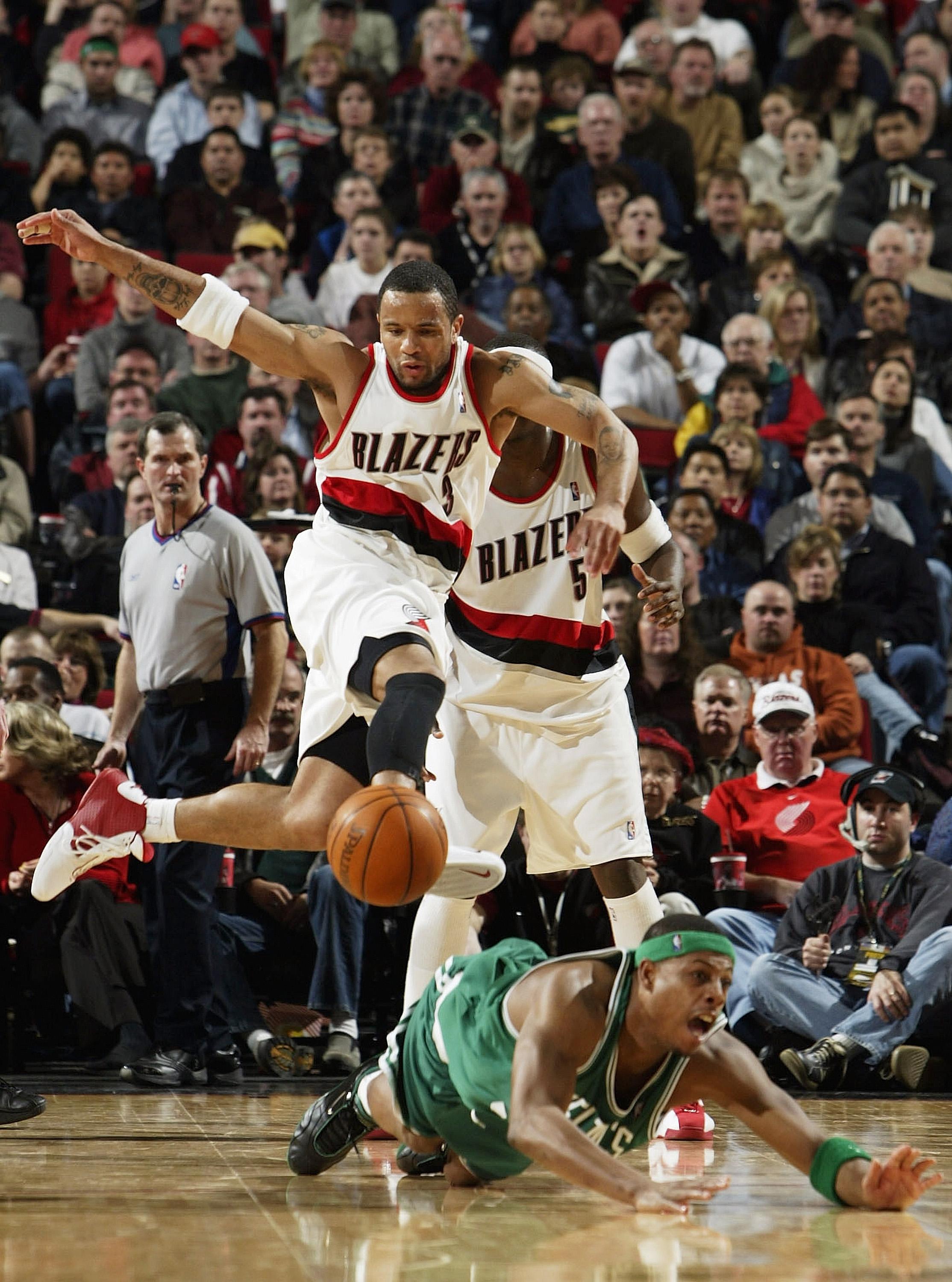 PORTLAND, OR - FEBRUARY 21:  Damon Stoudamire #3 of the Trail Blazers leaps over Paul Pierce #34 of the Celtics during the Boston Celtics versus Portland Trail Blazers game on February 21, 2004 at the Rose Garden in Portland, Oregon.  NOTE TO USER: User e