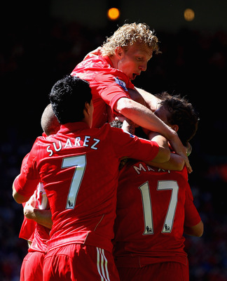 LIVERPOOL, ENGLAND - MAY 01: Dirk Kuyt,Luis Suarez celebrate with Team mate Maxi Rodriguez of Liverpool after he has scored the first goal during the Barclays Premier League match between Liverpool  and Newcastle United at Anfield on May 1, 2011 in Liverp