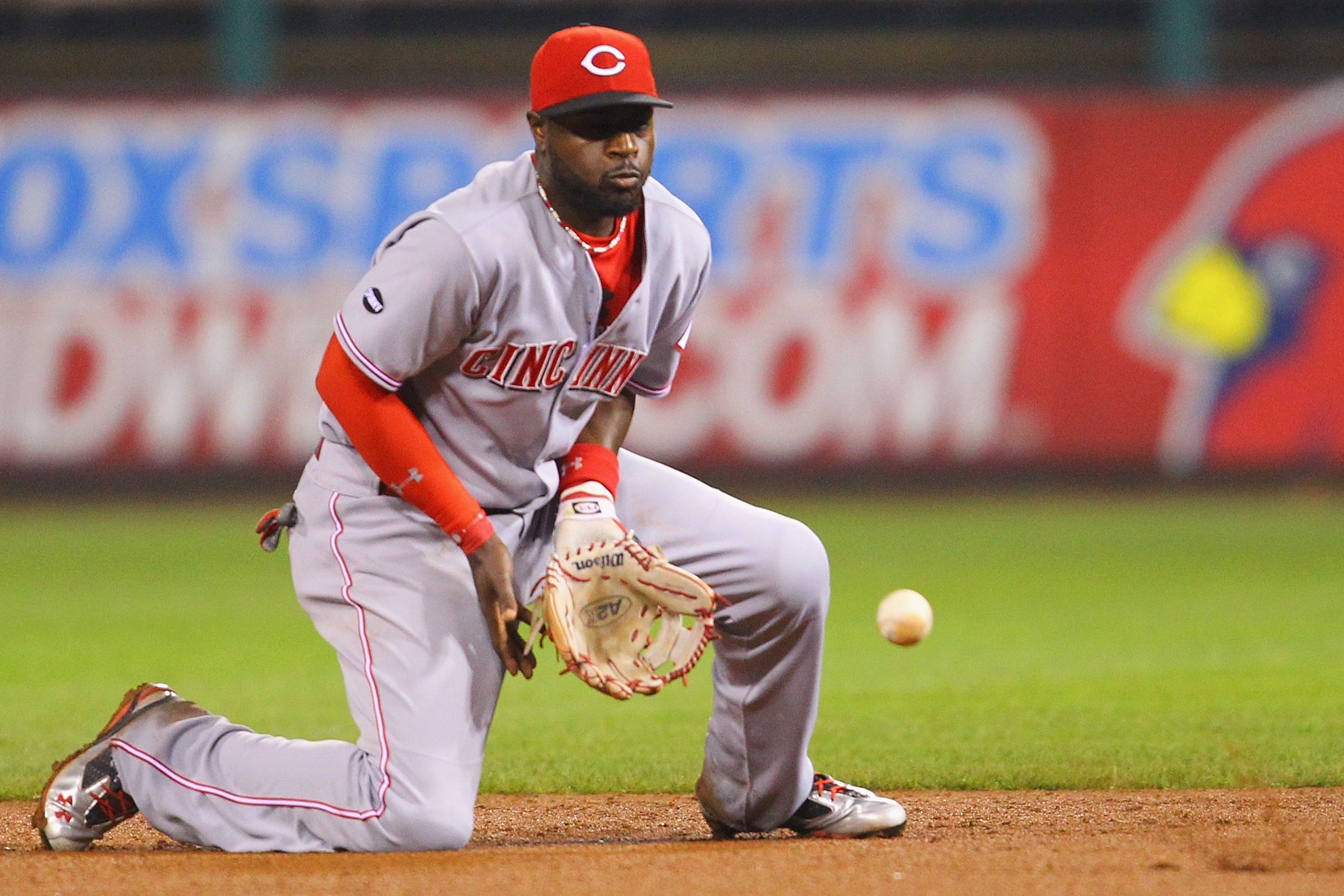 ST. LOUIS, MO - APRIL 22: Brandon Phillips #4 of the Cincinnati Reds fields a ground ball against the St. Louis Cardinals at Busch Stadium on April 22, 2011 in St. Louis, Missouri.  (Photo by Dilip Vishwanat/Getty Images)