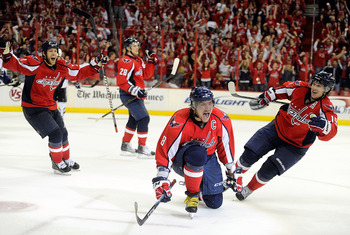 WASHINGTON, DC - MAY 01:  Alex Ovechkin #8 of the Washington Capitals celebrates with Brooks Laich #21, Alexander Semin #28, and Nicklas Backstrom #19 after scoring the tying goal in the third period against the Tampa Bay Lightning during Game Two of the