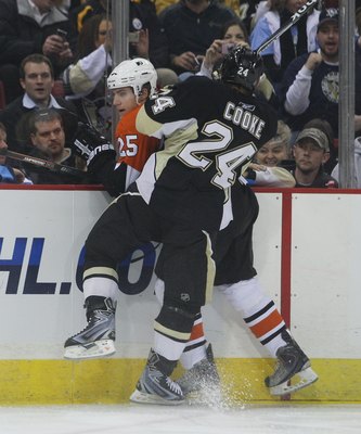 PITTSBURGH - DECEMBER 15: Matt Carle #25 of the Philadelphia Flyers is hit by Matt Cooke #24 of the Pittsburgh Penguins at the Mellon Arena on December 15, 2009 in Pittsburgh, Pennsylvania.  (Photo by Bruce Bennett/Getty Images)