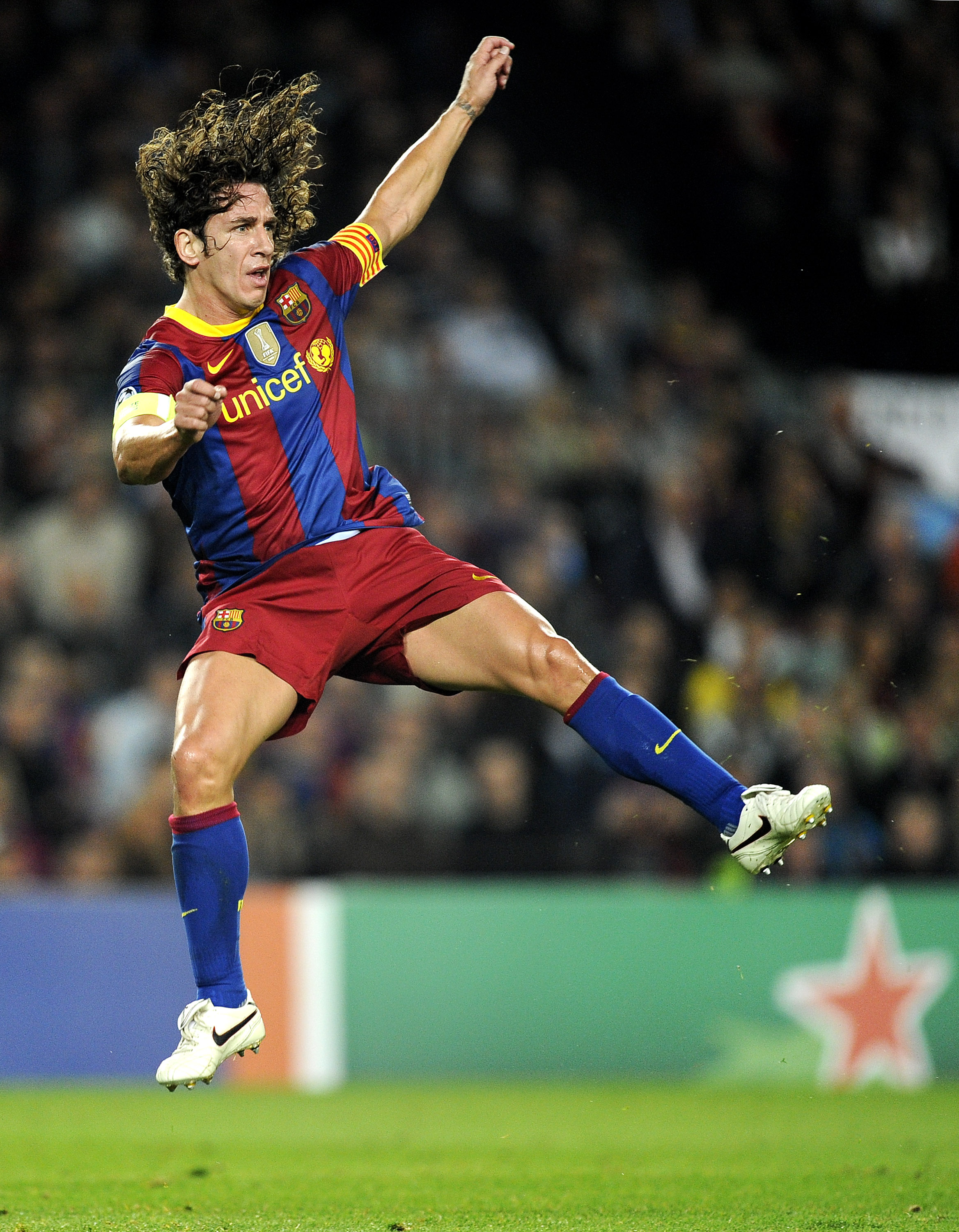 BARCELONA, SPAIN - OCTOBER 20:  Carles Puyol of Barcelona jumps after kicking the ball during the UEFA Champions League group D match between Barcelona and FC Copenhagen at the Camp nou stadium on October 20, 2010 in Barcelona, Spain. Barcelona won the ma