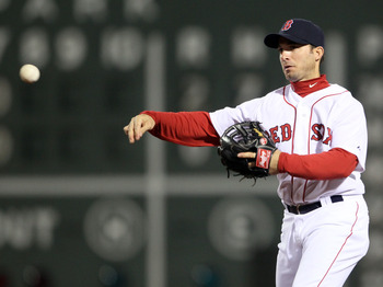 BOSTON, MA - APRIL 30:  Marco Scutaro #10 of the Boston Red Sox sends the ball to first for the out against the Seattle Mariners on April 30, 2011 at Fenway Park in Boston, Massachusetts.  (Photo by Elsa/Getty Images)