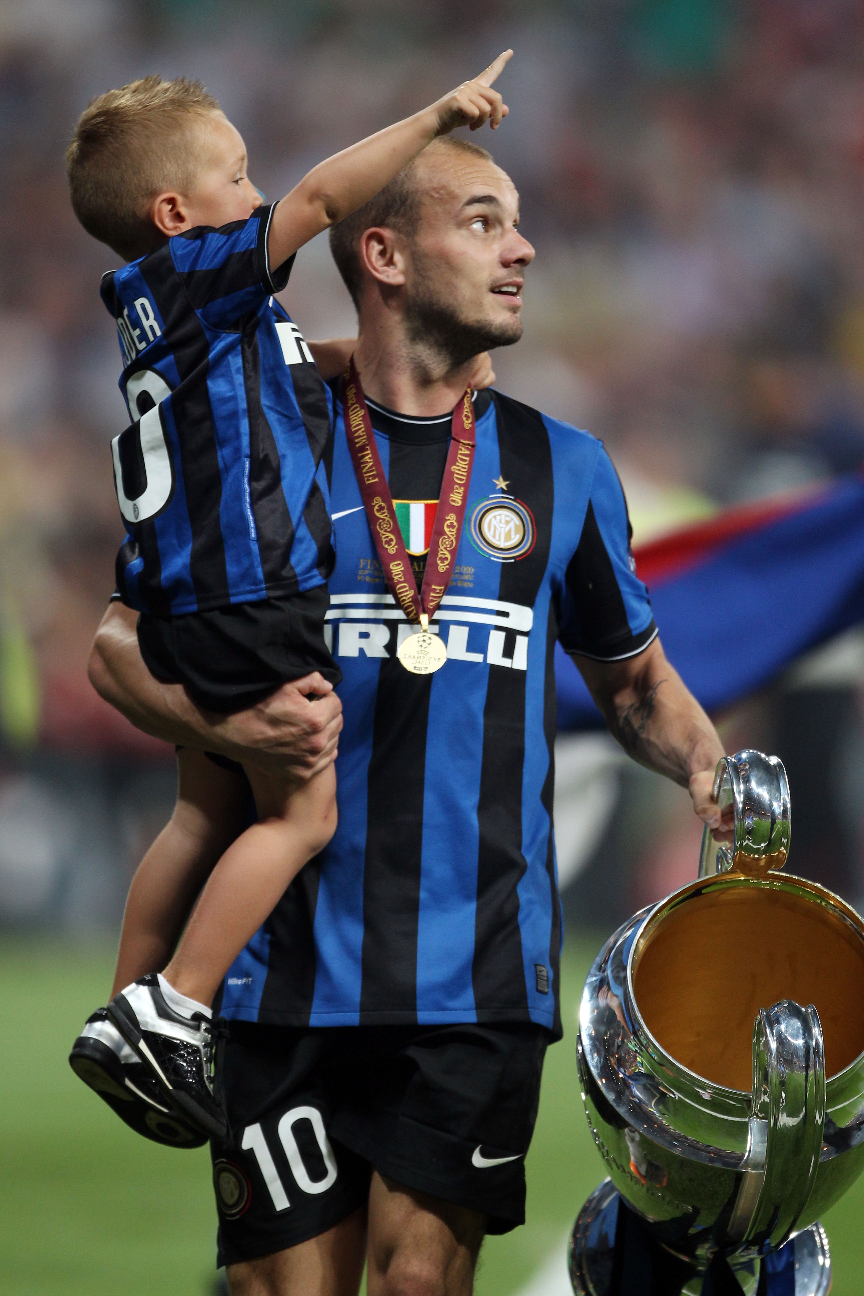 MADRID, SPAIN - MAY 22:  Wesley Sneijder of Inter Milan and his son celebrate with the UEFA Champions League trophy at the end of the UEFA Champions League Final match between FC Bayern Muenchen and Inter Milan at the Estadio Santiago Bernabeu on May 22,