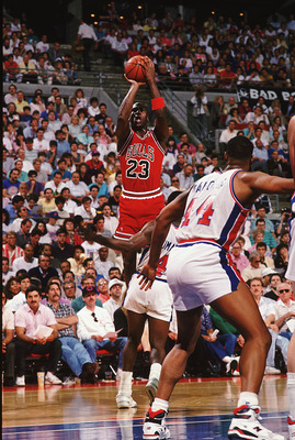 1988:  Michael Jordan #23 of the Chicago Bulls jumps to shoot the ball during a game against the Detroit Pistons. NOTE TO USER: It is expressly understood that the only rights Allsport are offering to license in this Photograph are one-time, non-exclusive