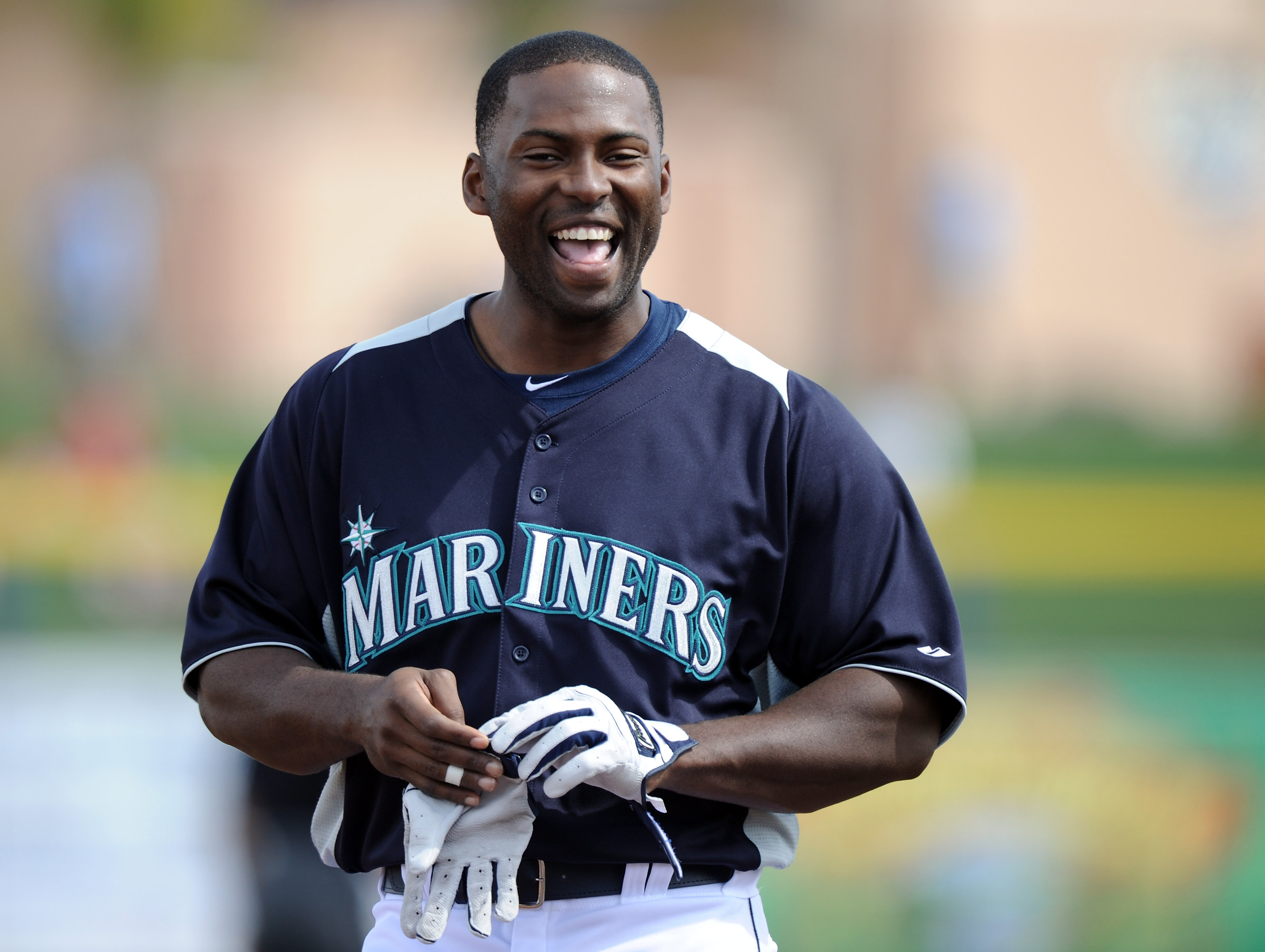 PEORIA, AZ - MARCH 01:  Milton Bradley #15 of the Seattle Mariners smiles as he leaves the field against the Texas Rangers during spring training at Peoria Stadium on March 1, 2011 in Peoria, Arizona.  (Photo by Harry How/Getty Images)