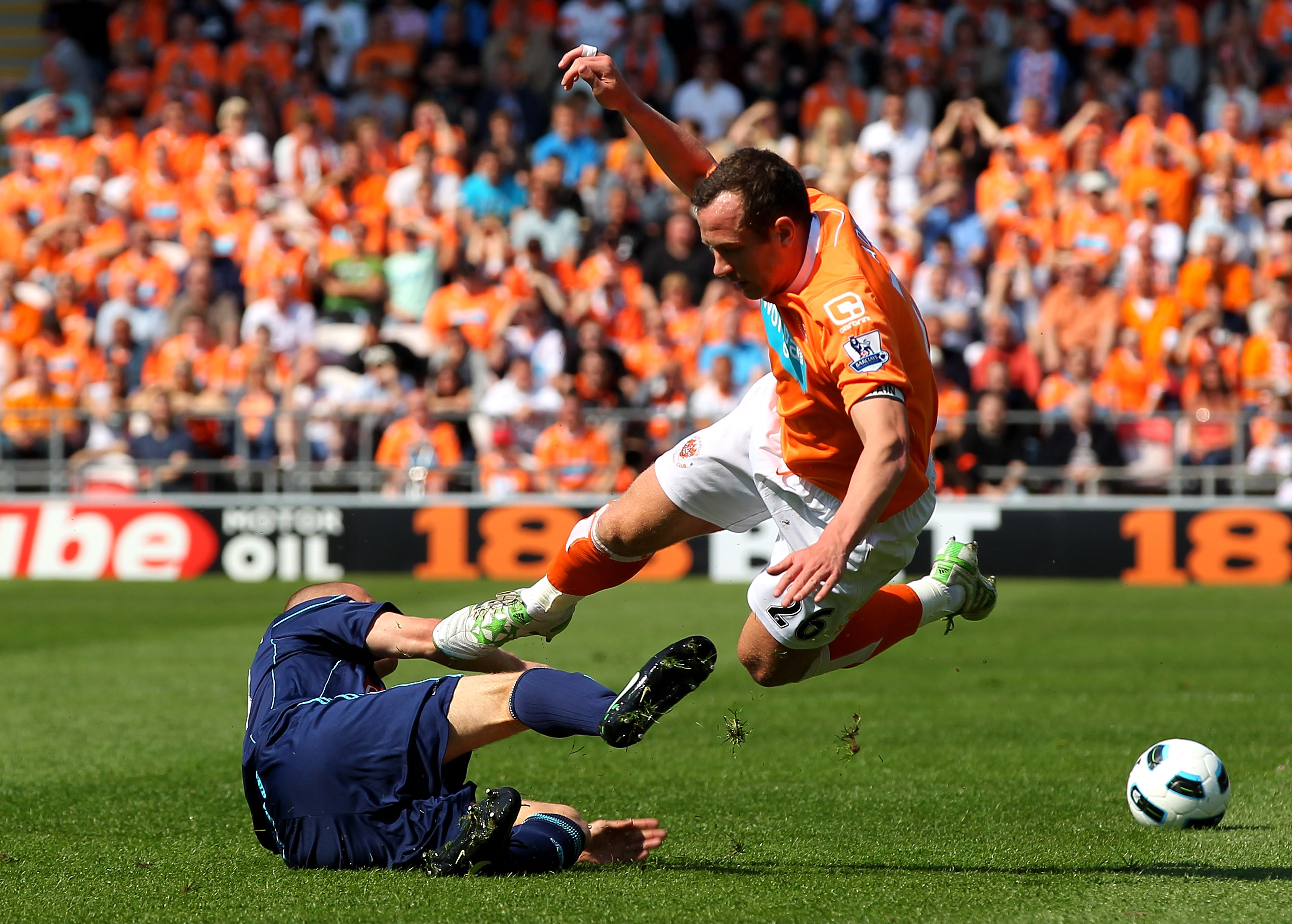 BLACKPOOL, ENGLAND - APRIL 30:   Andy Wilkinson of Stoke City challenges Charlie Adam of Blackpool during the Barclays Premier League match between Blackpool and Stoke City at Bloomfield Road on April 30, 2011 in Blackpool, England. (Photo by Clive Brunsk