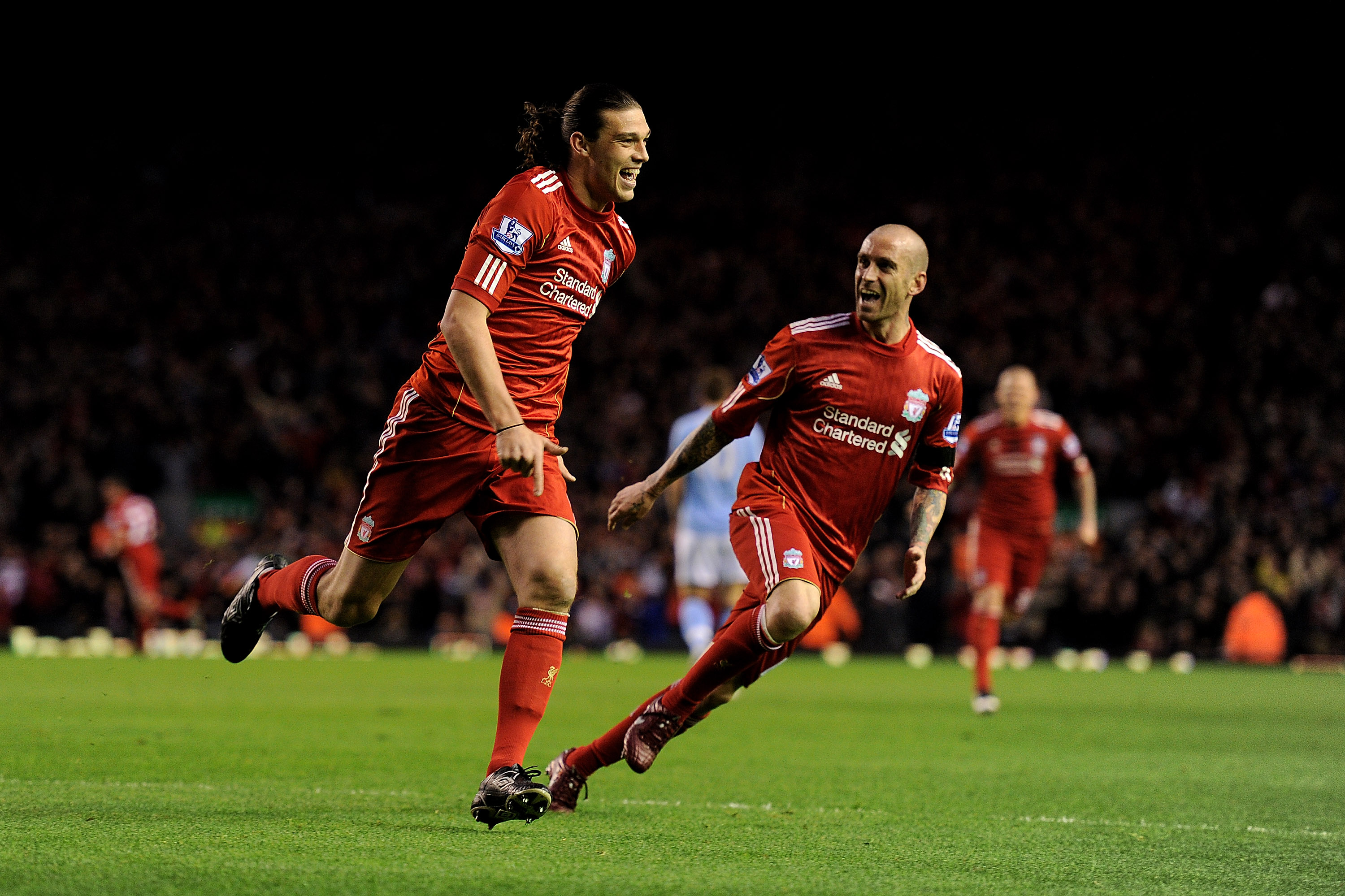 LIVERPOOL, ENGLAND - APRIL 11:  Andy Carroll of Liverpool celebrates scoring the opening goal with team mate Raul Meireles (R) during the Barclays Premier League match between Liverpool and Manchester City at Anfield on April 11, 2011 in Liverpool, Englan