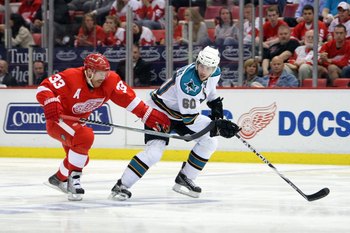 DETROIT - MAY 4:  Jason Demers #60 of the San Jose Sharks skates against Kris Draper #33 of the Detroit Red Wings in Game Three of the Western Conference Semifinals during the 2010 Stanley Cup Playoffs at Joe Louis Arena on May 4, 2010 in Detroit, Michiga