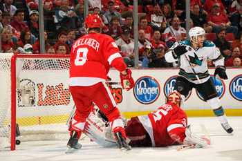 DETROIT - MAY 4:  Joe Pavelski #8 of the San Jose Sharks celebrates the game-tying goal in the third period by Dan Boyle #22 of the San Jose Sharks as goaltender Jimmy Howard #35 of the Detroit Red Wings and Justin Abdelkader #8 of the Detroit Red Wings w