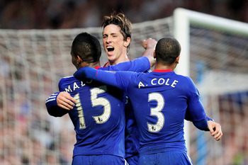 LONDON, ENGLAND - APRIL 23:  Florent  Malouda (L) of Chelsea celebrates with teammates Fernando Torres and Ashley Cole after scoring his team's third goal during the Barclays Premier League match between Chelsea and West Ham United at Stamford Bridge on A