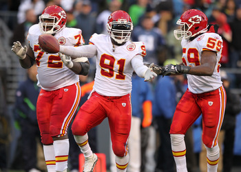 SEATTLE, WA - NOVEMBER 28:  Linebacker Tamba Hali #91 of the Kansas City Chiefs celebrates with Glenn Dorsey #72 and Jovan Belcher #59 after recovering a fumble on a sack of quarterback Matt Hasselbeck of the Seattle Seahawks at Qwest Field on November 28