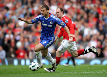 MANCHESTER, ENGLAND - MAY 08:  Wayne Rooney of Manchester United competes with Branislav Ivanovic of Chelsea during the Barclays Premier League match between Manchester United and Chelsea at Old Trafford on May 8, 2011 in Manchester, England.  (Photo by A
