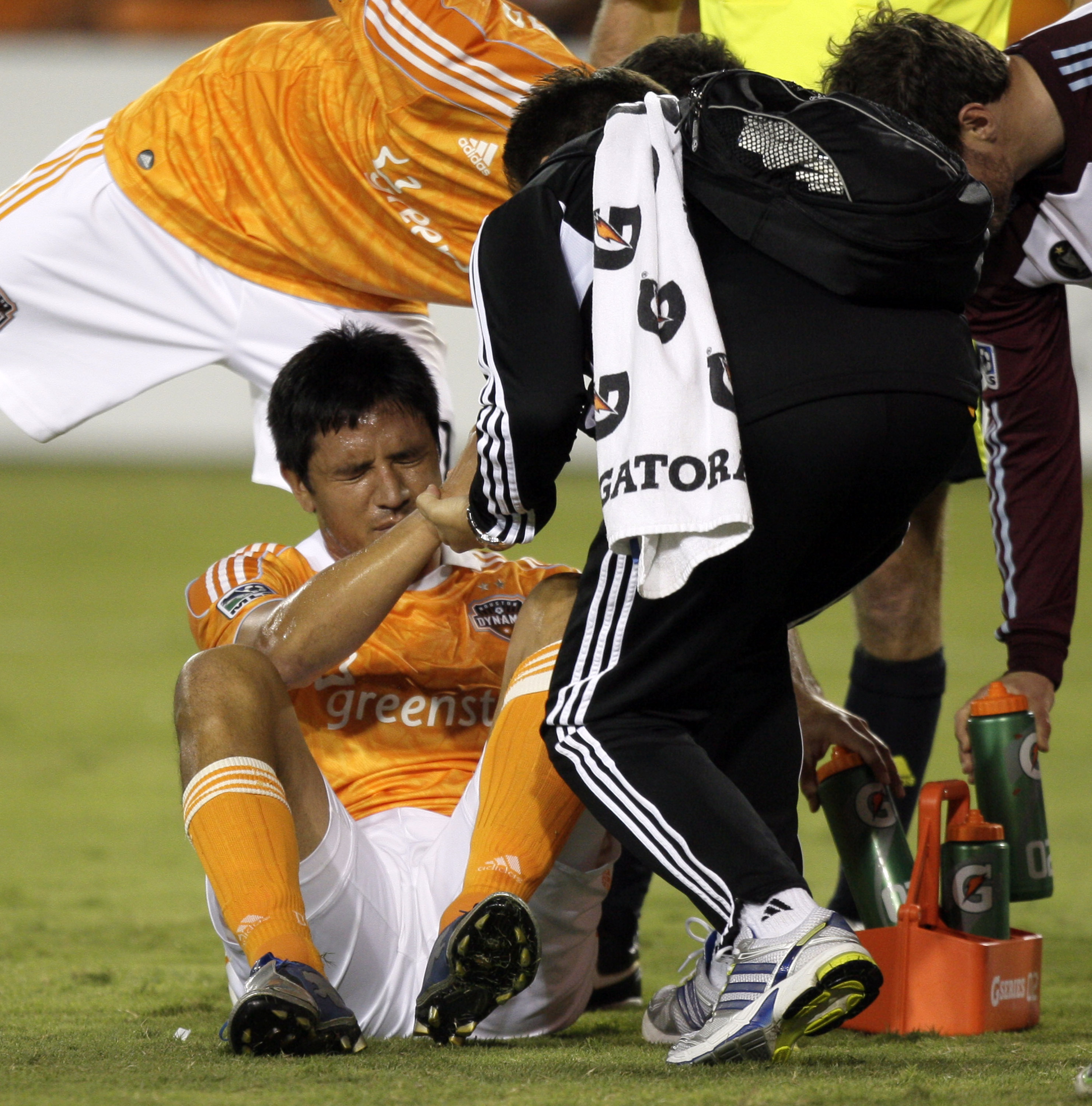 HOUSTON - MAY 04: Brian Ching #25 of the Houston Dynamo is helped up after being shaken up in the second half against the Colorado Rapids at Robertson Stadium on May 4, 2011 in Houston, Texas. (Photo by Bob Levey/Getty Images)