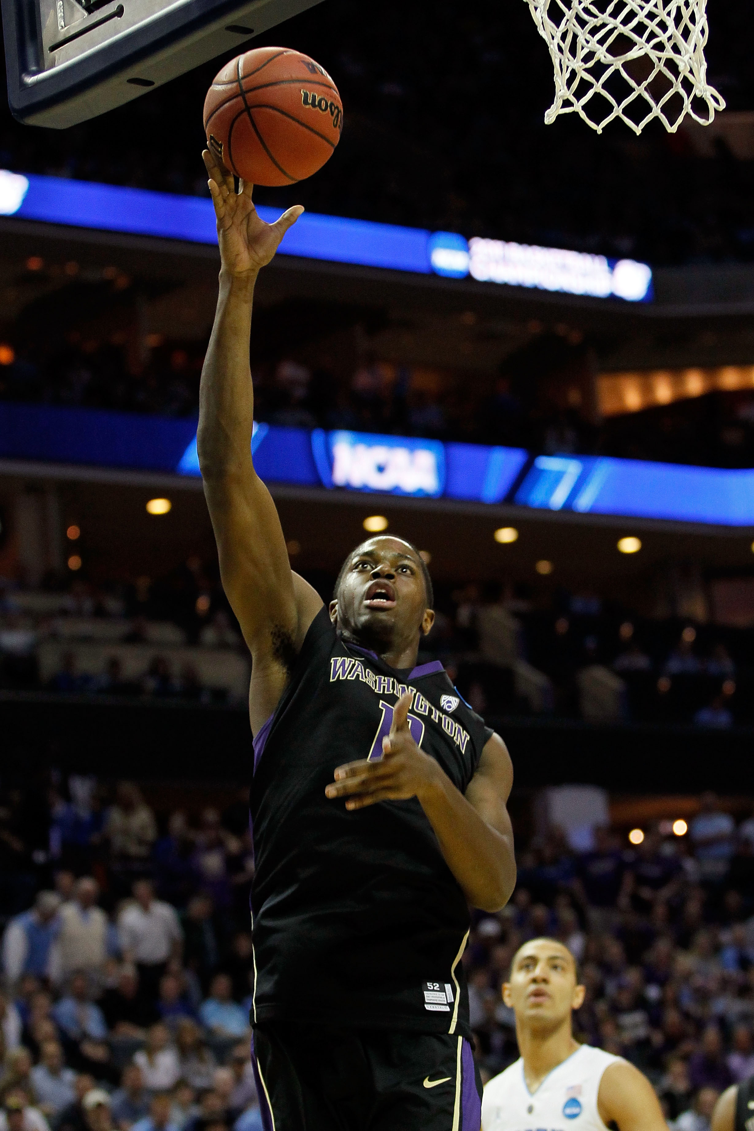 CHARLOTTE, NC - MARCH 20: Matthew Bryan-Amaning #11 of the Washington Huskies lays the ball up while taking on the North Carolina Tar Heels during the third round of the 2011 NCAA men's basketball tournament at Time Warner Cable Arena on March 20, 2011 i