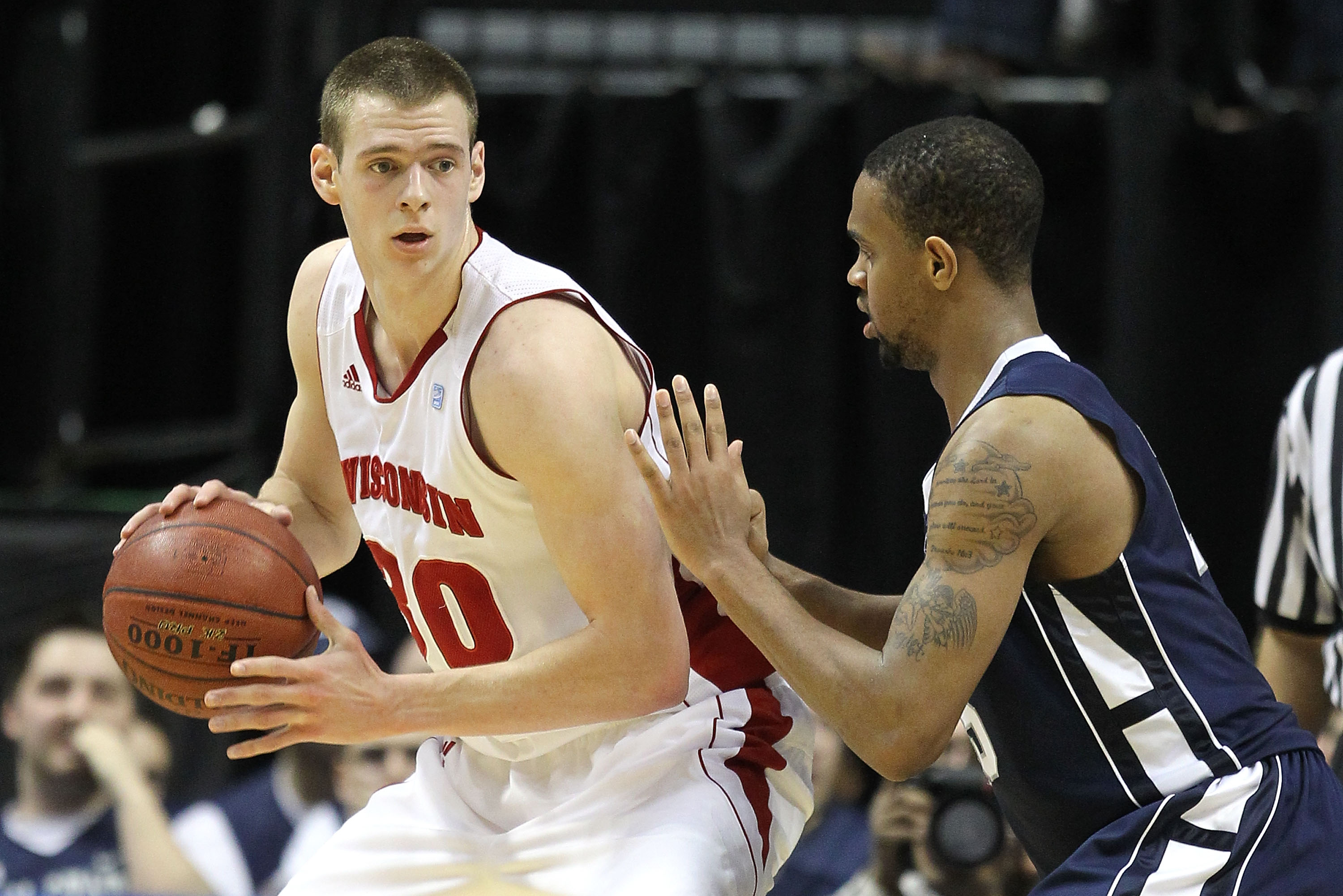 INDIANAPOLIS, IN - MARCH 11:  Jon Leuer #30 of the Wisconsin Badgers posts up against David Jackson #15 of the Penn State Nittany Lions during the quarterfinals of the 2011 Big Ten Men's Basketball Tournament at Conseco Fieldhouse on March 11, 2011 in Ind