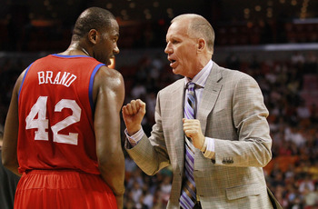 MIAMI, FL - MARCH 25:  Coach Doug Collins and Guard Elton Brand #42 of the Philadelphia Sixers chat against the Miami Heat at American Airlines Arena on March 25, 2011 in Miami, Florida. The Heat defeated the Sixers 111-99. NOTE TO USER: User expressly ac