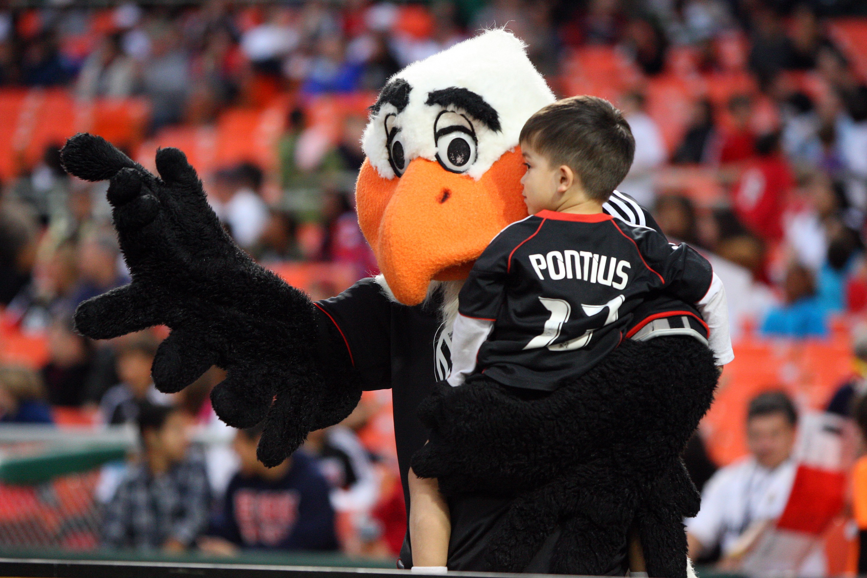 WASHINGTON, DC - MAY 7: Mascot Talon of D.C. United holds a young fan against FC Dallas at RFK Stadium on May 7, 2011 in Washington, DC. (Photo by Ned Dishman/Getty Images)