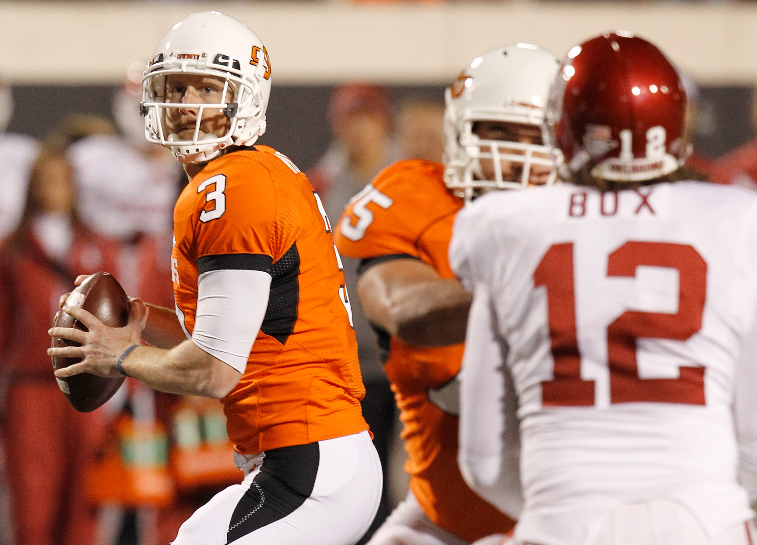 STILLWATER, OK - NOVEMBER 27:  Quarterback Brandon Weeden #3 of the Oklahoma State Cowboys looks for an open receiver against the Oklahoma Sooners at Boone Pickens Stadium on November 27, 2010 in Stillwater, Oklahoma.  (Photo by Tom Pennington/Getty Image