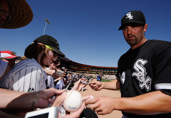 GLENDALE, AZ - MARCH 11: Paul Konerko #14 of the Chicago White Sox signs baseballs prior to the start of the spring training baseball game against  Chicago Cubs at Camelback Ranch on March 11, 2011 in Glendale, Arizona.  (Photo by Kevork Djansezian/Getty