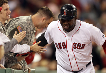 BOSTON, MA - MAY 02:  David Ortiz #34 of the Boston Red Sox celebrates his two run homer with military members sitting in the front row in the seventh inning against the Los Angeles Angels on May 2, 2011 at Fenway Park in Boston, Massachusetts.  (Photo by