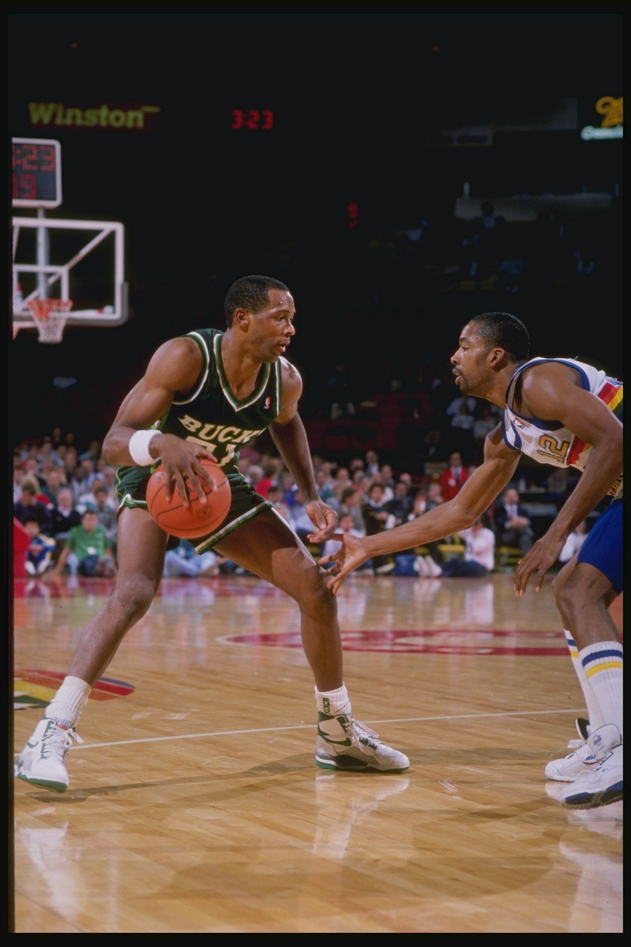 1989-1990:  Guard Alvin Robertson of the Milwaukee Bucks (left) in action with the ball during a game against the Denver Nuggets at McNichols Arena in Denver, Colorado. Mandatory Credit: Tim de Frisco  /Allsport