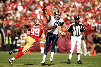 SAN FRANCISCO - NOVEMBER 14:  Sam Bradford #8 of the St. Louis Rams throws the ball as he is hit by Manny Lawson #99 of the San Francisco 49ers at Candlestick Park on November 14, 2010 in San Francisco, California.  (Photo by Ezra Shaw/Getty Images)