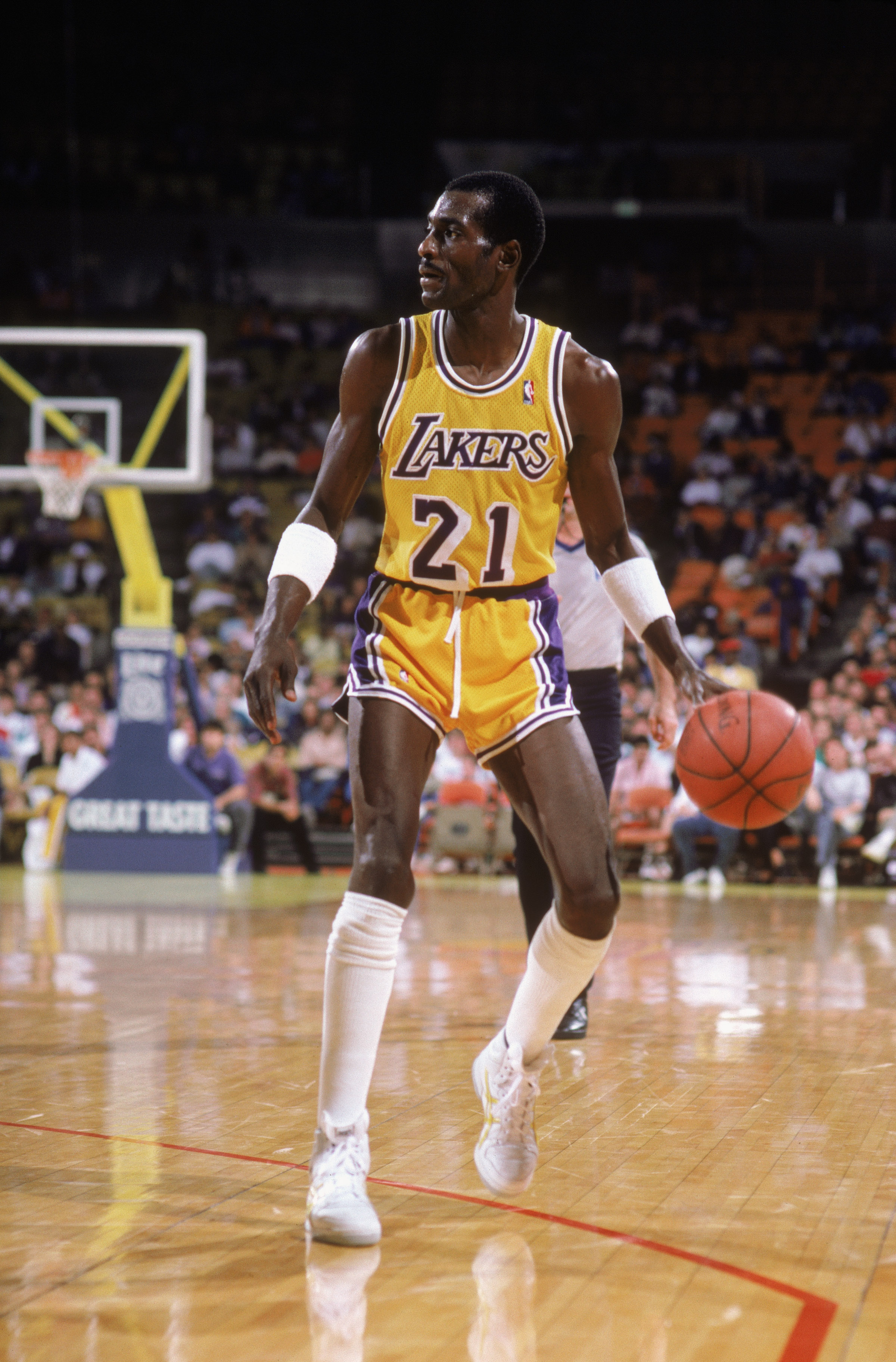 LOS ANGELES - 1987:  Michael Cooper #21 of the Los Angeles Lakers dribbles the ball during an NBA game at the Great Western Forum in Los Angeles, California in 1987. (Photo by: Rick Stewart/Getty Images)