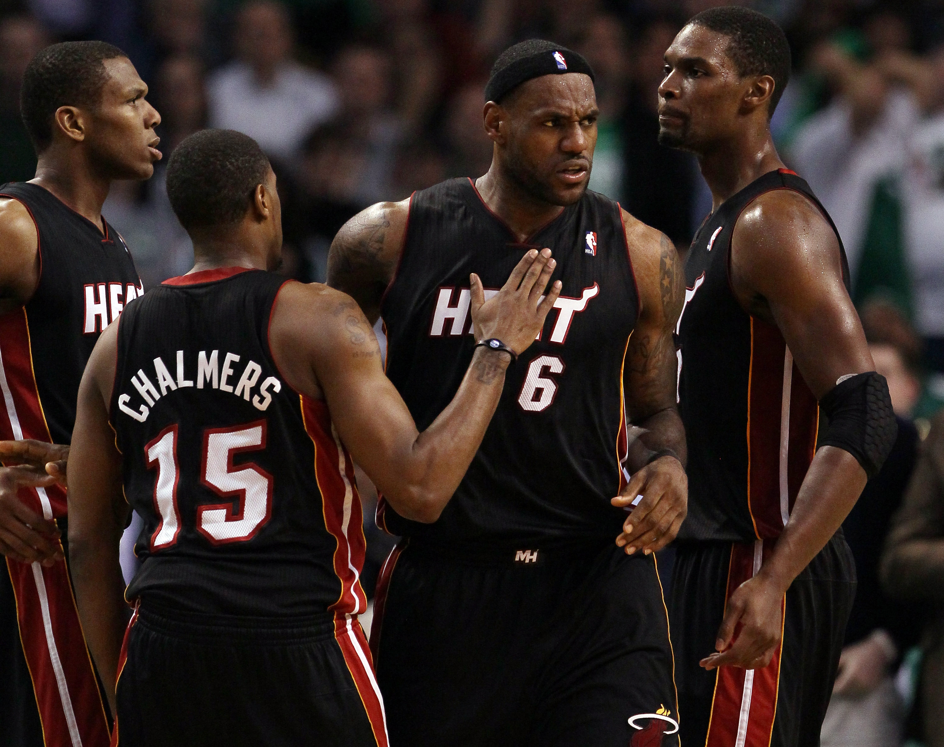 BOSTON, MA - MAY 09: LeBron James #6 of the Miami Heat is congratulated by teammates Chris Bosh #1 and Mario Chalmers #15 after James drew the foul in the second half against the Boston Celtics in Game Four of the Eastern Conference Semifinals in the 201