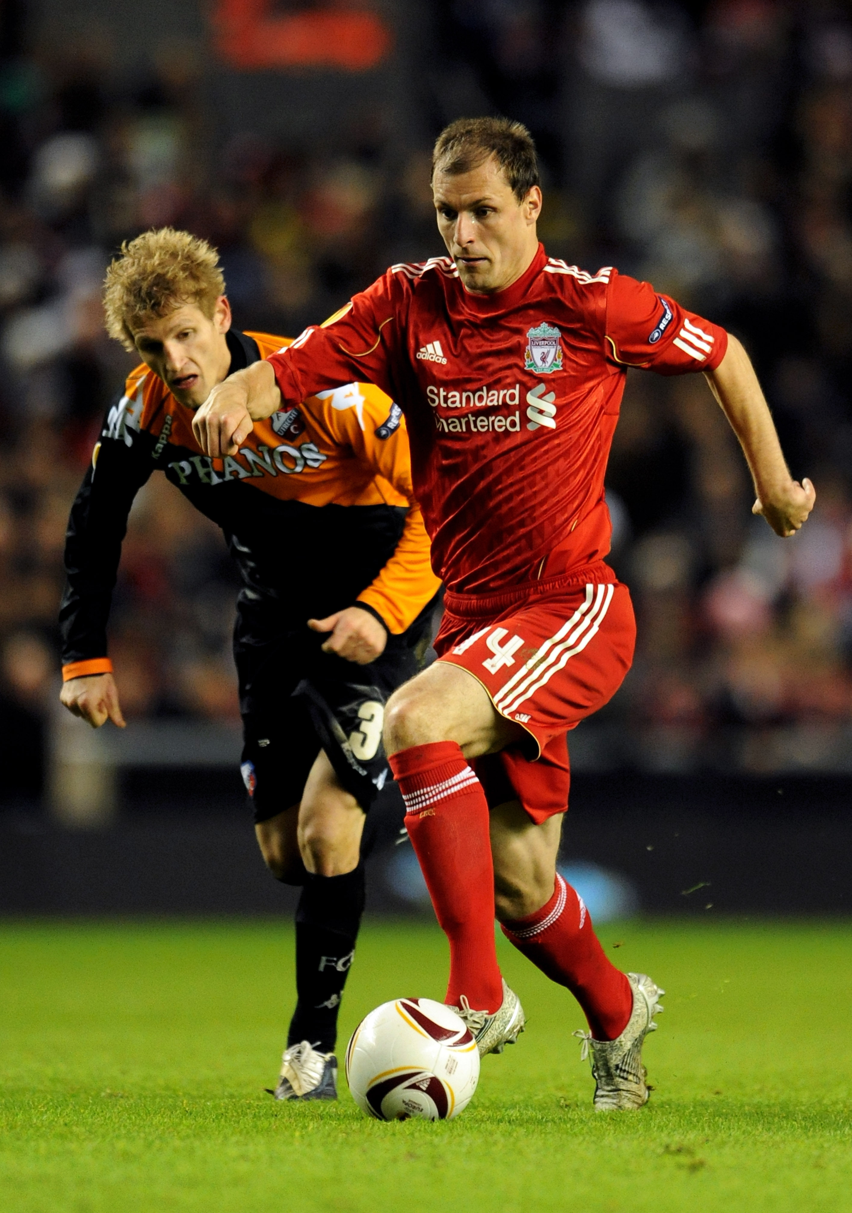 LIVERPOOL, ENGLAND - DECEMBER 15:  Milan Jovanovic of Liverpool is pursued by Mihai Nesu of FC Utrecht during the UEFA Europa League Group K match between Liverpool and FC Utrecht at Anfield on December 15, 2010 in Liverpool, England.  (Photo by Clint Hug