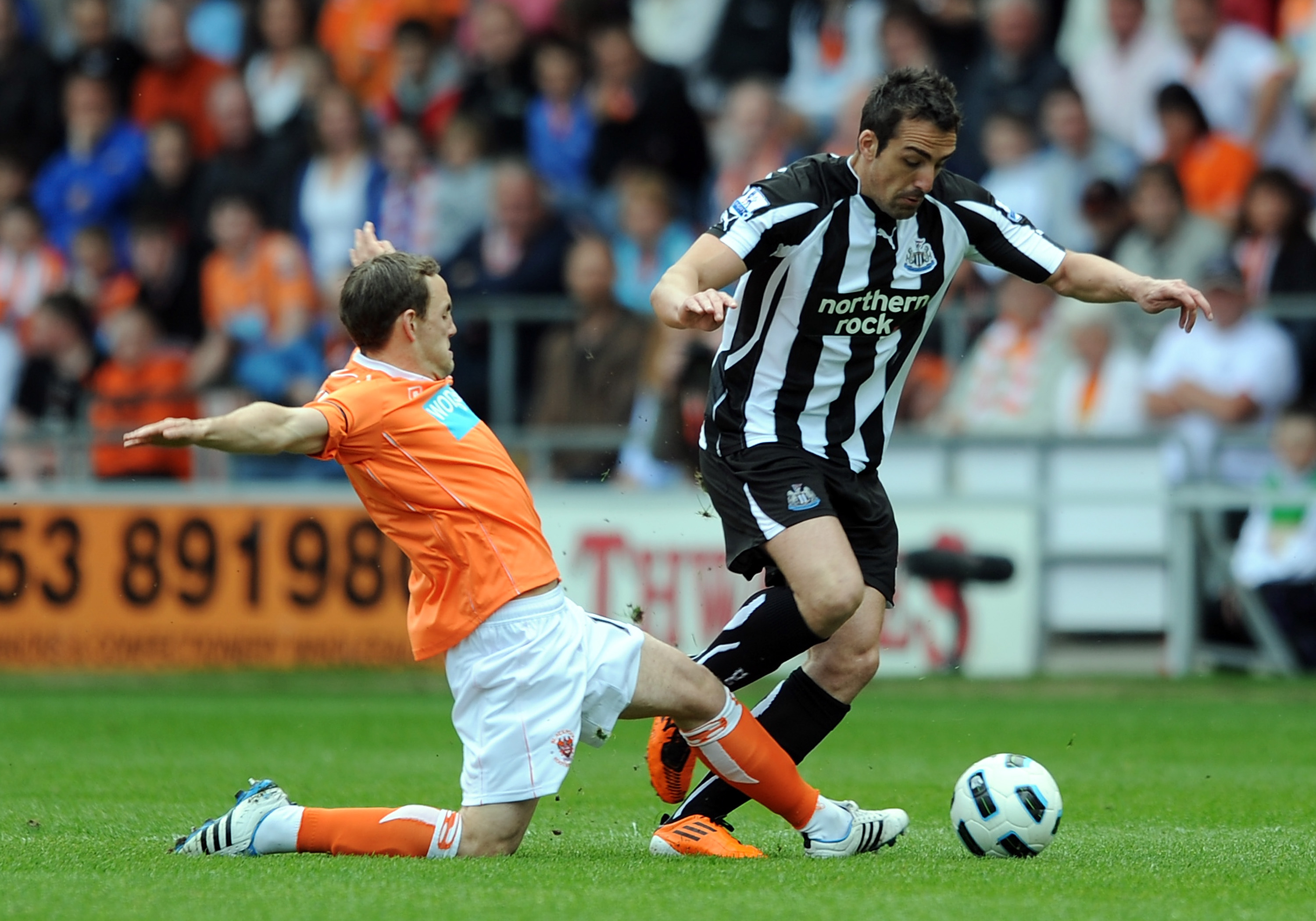 BLACKPOOL, ENGLAND - APRIL 23:  David Vaughan of Blackpool challenges Jose Enrique of Newcastle United during the Barclays Premier League match between Blackpool and Newcastle United at Bloomfield Road on April 23, 2011 in Blackpool, England.  (Photo by C