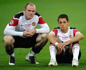LONDON, ENGLAND - MAY 28: Wayne Rooney of Manchester United (L) and Javier Hernandez show their dissapointment after defeat in the UEFA Champions League final between FC Barcelona and Manchester United FC at Wembley Stadium on May 28, 2011 in London, Engl