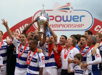 LONDON, ENGLAND - MAY 07:  Queens Park Rangers players celebrates with the trophy after winning the npower Championship match between Queens Park Rangers and Leeds United at Loftus Road on May 7, 2011 in London, England.  (Photo by Ian Walton/Getty Images