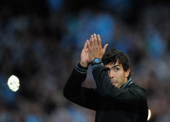 MANCHESTER, ENGLAND - MAY 23:  Carlos Tevez of Manchester City waves to the fans during the Manchester City FA Cup Winners Parade at the City of Manchester stadium on May 23, 2011 in Manchester, United Kingdom.  (Photo by Jamie McDonald/Getty Images)