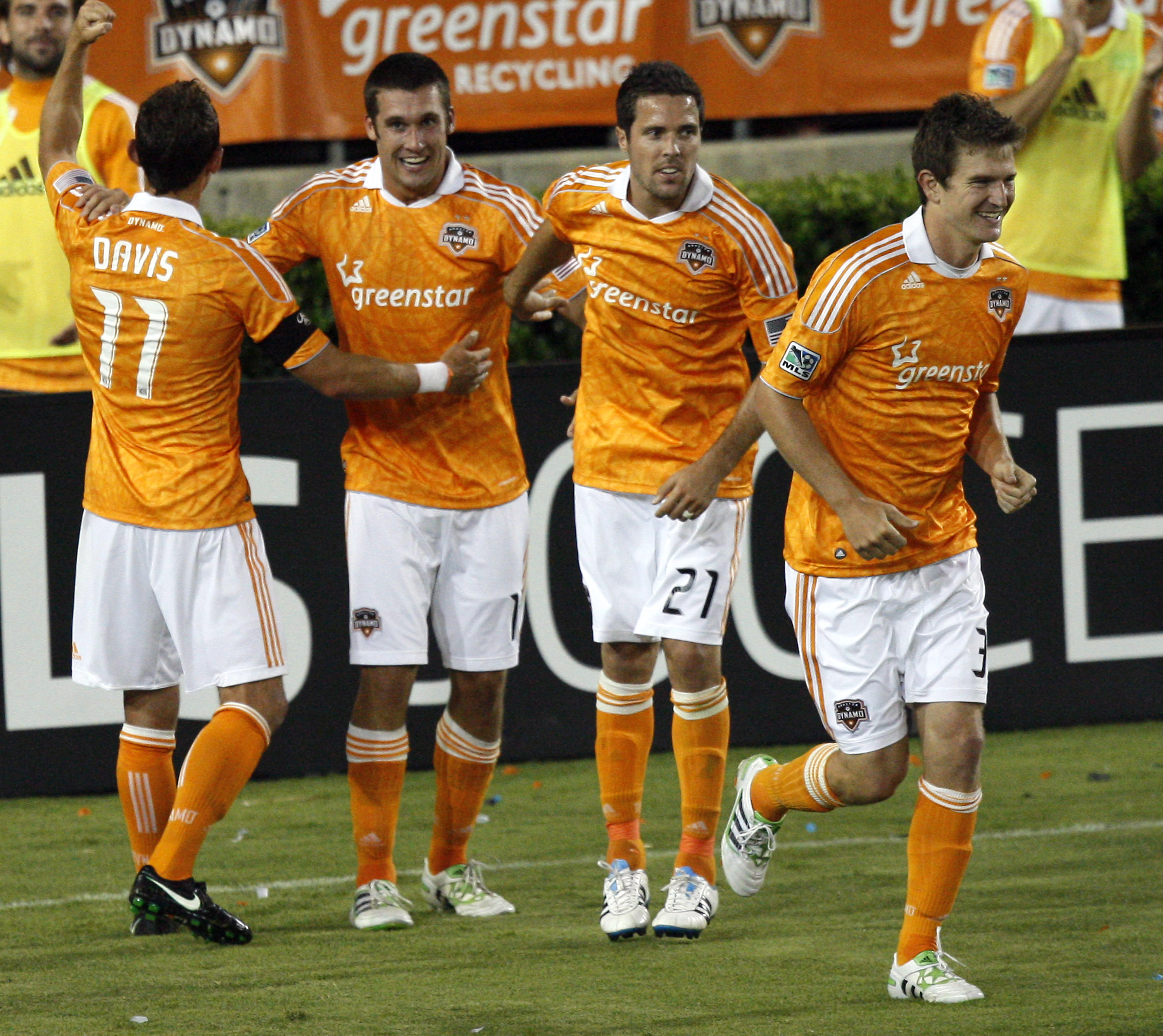 HOUSTON - APRIL 29: Forward Will Bruin #12, second from left, of the Houston Dynamo is congratulated by Brad Davis #11, Hunter Freeman #21 and Bobby Boswell #32 after scoring his third goal of the game in the second half against D.C. United at Robertson