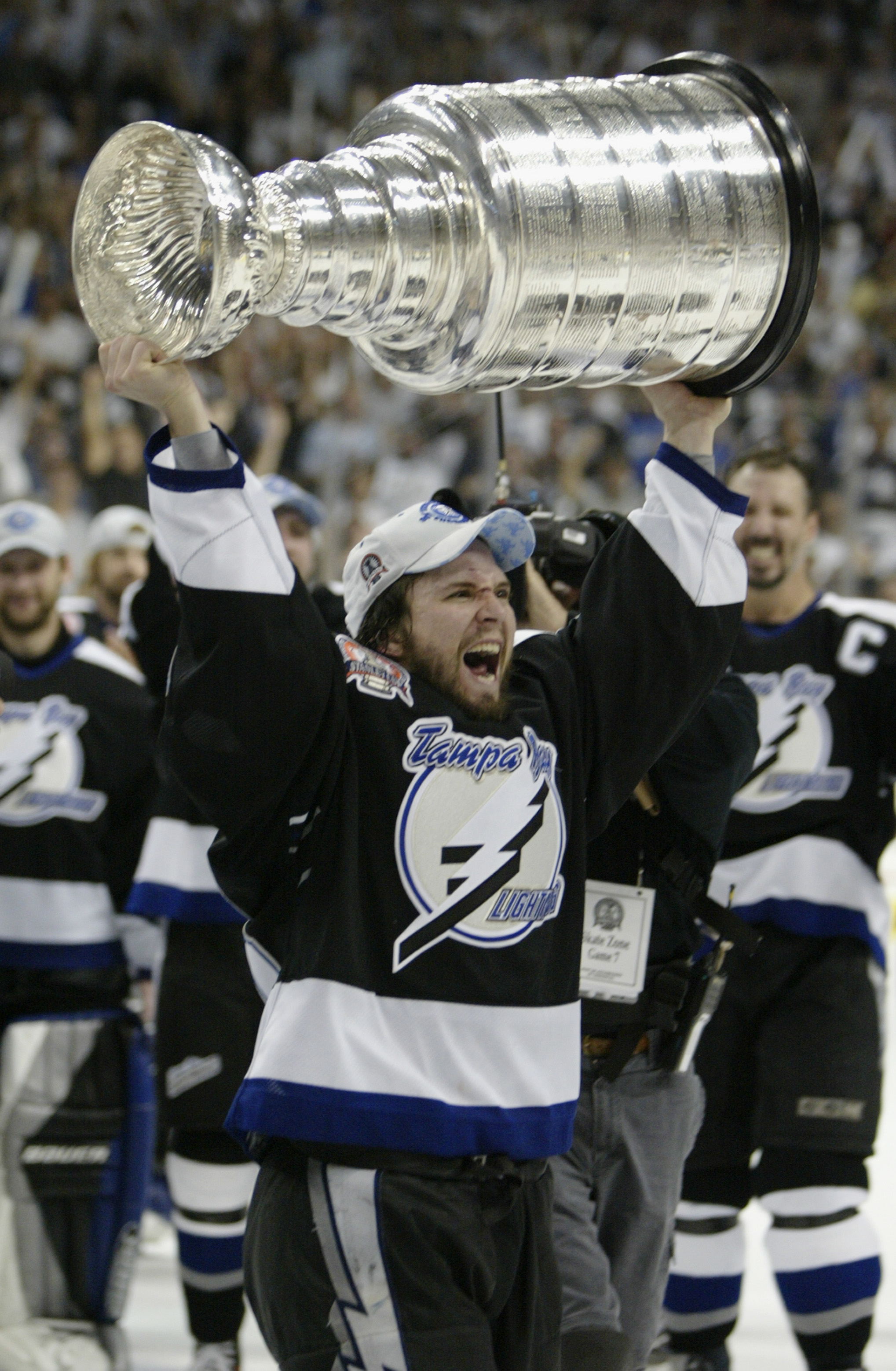 TAMPA, FL - JUNE 7:  Martin St. Louis #26 of the Tampa Bay Lightning holds the Stanley Cup above his head after the victory over the Calgary Flames in Game seven of the NHL Stanley Cup Finals on June 7, 2004 at the St. Pete Times Forum in Tampa, Florida.