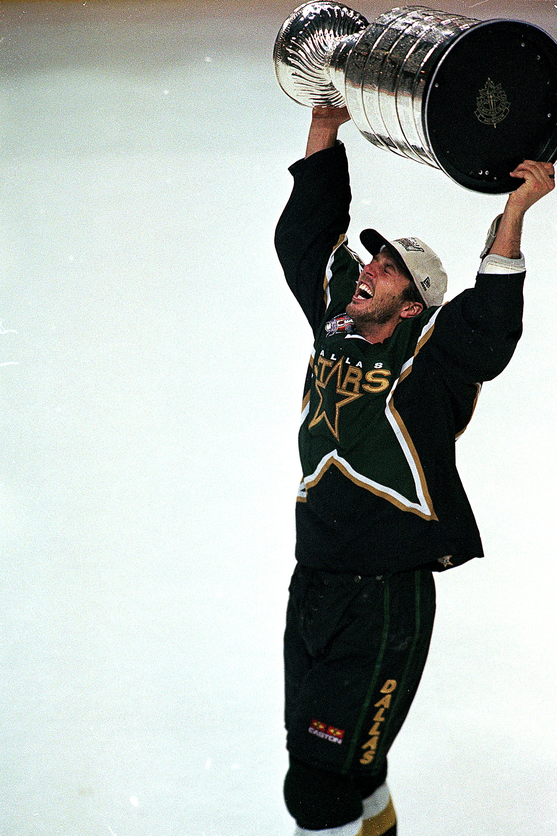 19 Jun 1999: Mike Modano #9 of the Dallas Stars carries the Stanley Cup on the ice after the Stanley Cup game against the Buffalo Sabres at the Marine Midland Arena in Buffalo, New York. The Stars defeated the Sabres 2-1 in triple overtime.