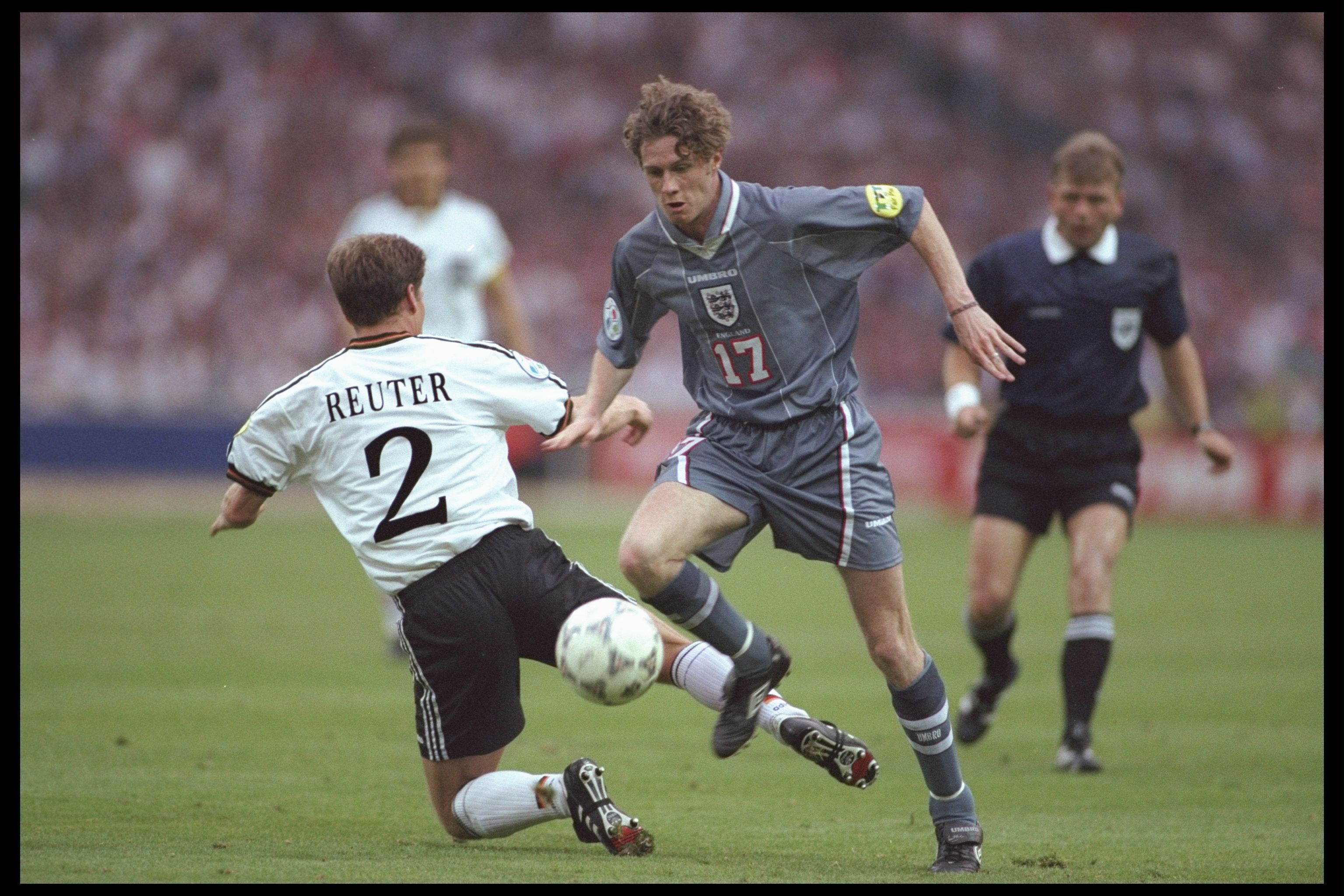 26 Jun 1996:  Steve McManaman of England (number 17) goes round Stefan Reuter of Germany during the European soccer championships semi final match between England and Germany at Wembley Stadium, London. Germany won the match after extra time in a penaltys