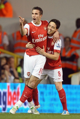 LONDON, ENGLAND - APRIL 20:  Robin van Persie of Arsenal celebrates scoring their third goal with team mate Samir Nasri during the Barclays Premier League match between Tottenham Hotspur and Arsenal at White Hart Lane on April 20, 2011 in London, England.
