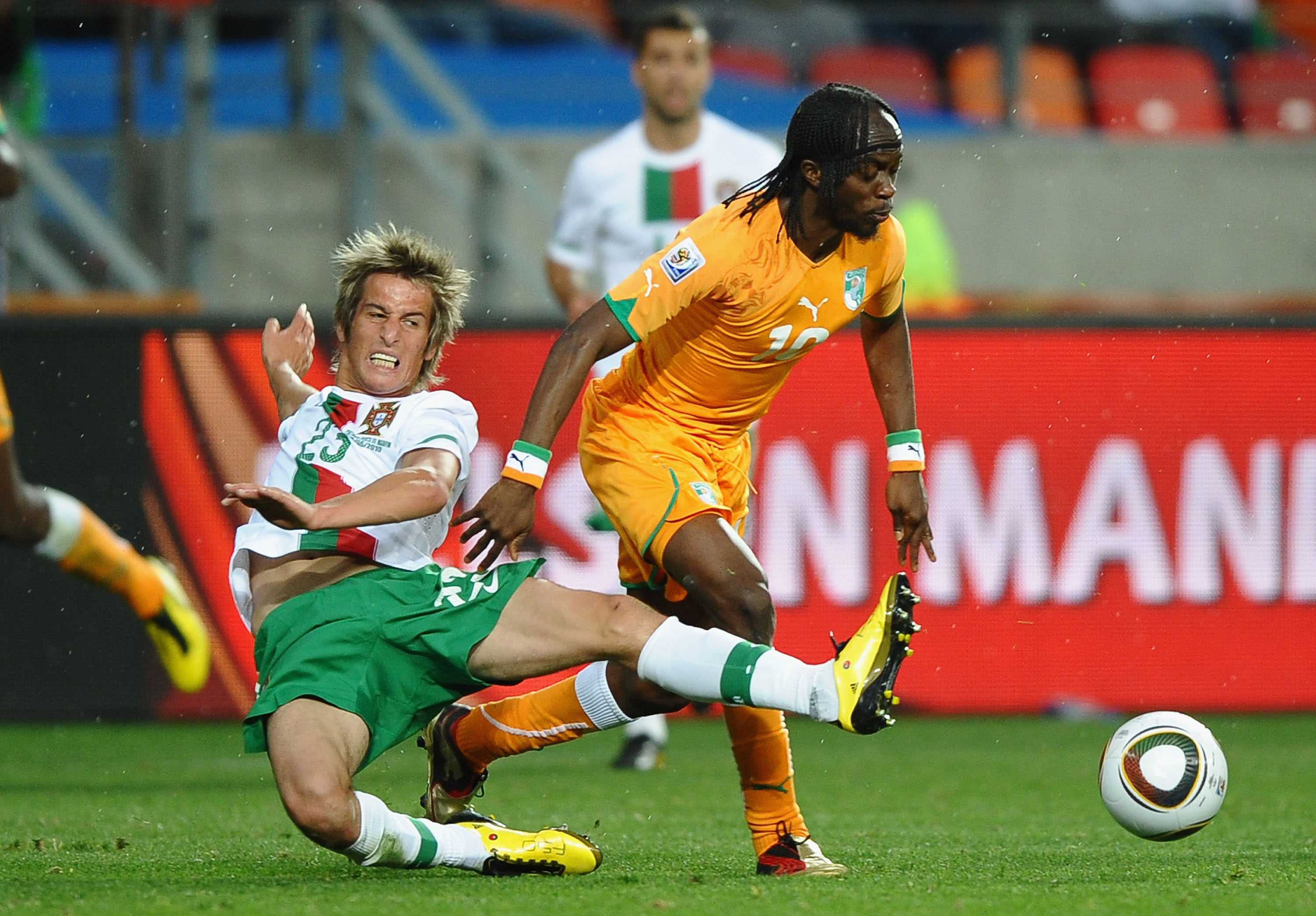 PORT ELIZABETH, SOUTH AFRICA - JUNE 15:  Gervinho of Ivory Coast is tackled by Fabio Coentrao of Portugal during the 2010 FIFA World Cup South Africa Group G match between Ivory Coast and Portugal at Nelson Mandela Bay Stadium on June 15, 2010 in Port Eli