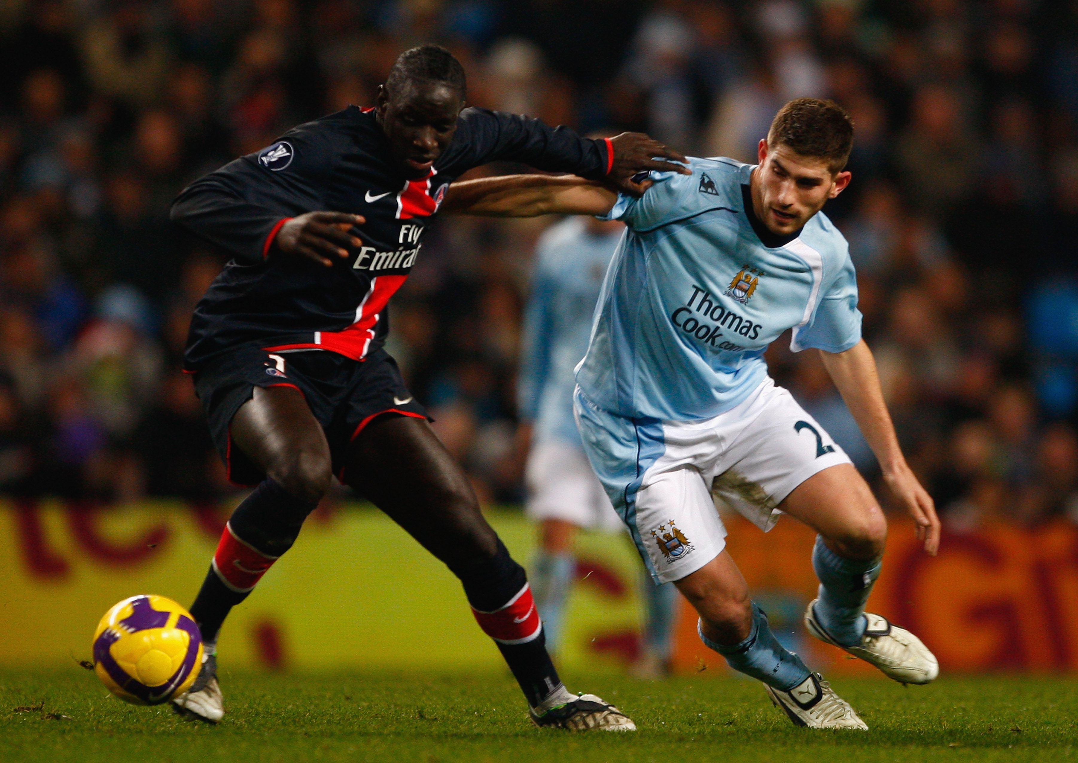 MANCHESTER, UNITED KINGDOM - DECEMBER 03:  Sakho Mamadou of Paris Saint Germain battles for the ball with Ched Evans of Manchester City during the UEFA Cup Group A match between Manchester City and Paris Saint-Germain at The City of Manchester Stadium on 