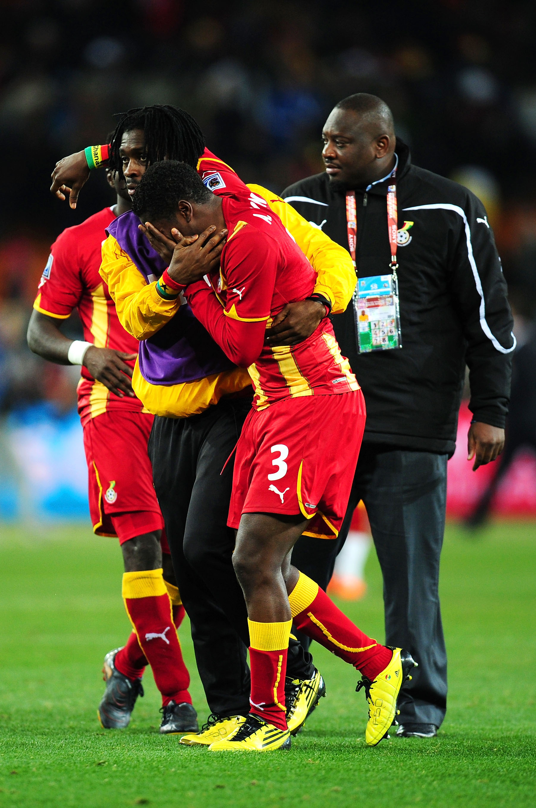 JOHANNESBURG, SOUTH AFRICA - JULY 02:  Asamoah Gyan of Ghana is consoled after his team are knocked out in a penalty shoot out during the 2010 FIFA World Cup South Africa Quarter Final match between Uruguay and Ghana at the Soccer City stadium on July 2,