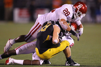 COLUMBIA, MISSOURI - OCTOBER 23: T.J. Moe #28 of the Missouri Tigers is tackled by Travis Lewis #28 of the Oklahoma Sooners at Faurot Field/Memorial Stadium on October 23, 2010 in Columbia, Missouri.  The Tigers beat the Sooners 36-27.  (Photo by Dilip Vi