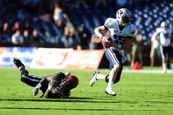 SAN DIEGO - OCTOBER 17:  Max Hall #15 of BYU Cougars runs the ball and avoids getting tackeled by Miles Burris #9 of San Diego State Aztecs at Qualcomm Stadium on October 17, 2009 in San Diego, California. BYU Cougars defeated the Aztecs 38-28  (Photo by 