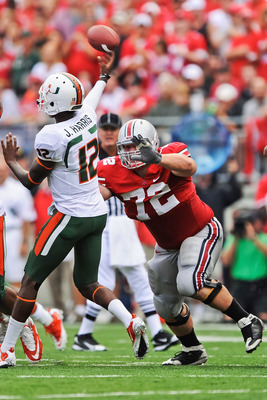 COLUMBUS, OH - SEPTEMBER 11:  Dexter Larimore #72 of the Ohio State Buckeyes applies pressure to quarterback Jacory Harris #12 of the Miami Hurricanes at Ohio Stadium on September 11, 2010 in Columbus, Ohio.  (Photo by Jamie Sabau/Getty Images)